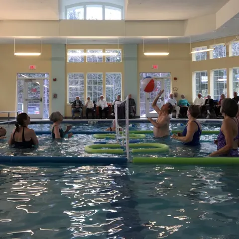 Older adults play water volleyball through U-ExCEL program